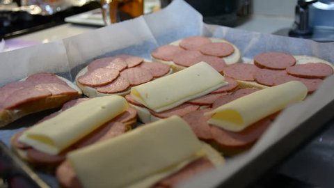 mans hand making hot sanwiches. Ingredients and making of a croque monsieur French ham and cheese sandwich, toasted, meal, gruyere, 
