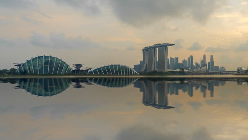 Beautiful Time lapse of Day to Night of Singapore skyline with reflection. Prores 4K. Pan to right Camera Motion. Royalty-Free Stock Footage #1020976495