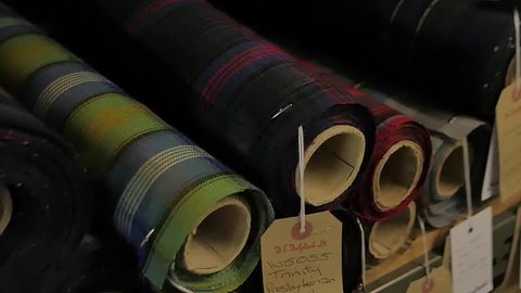 Various wool spools inside a waving mill - Scottish Tartan texite production - Slow motion footage on a slider