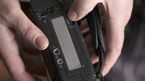 Inserting mini DV cassette tape into the camcorder