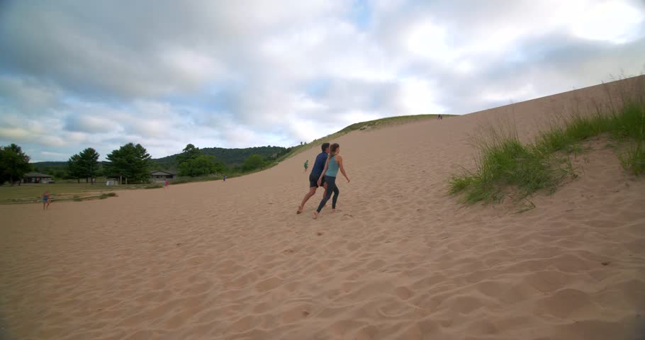 Couple Walking Up Dunes, Sleeping Bear Dunes, Michigan
