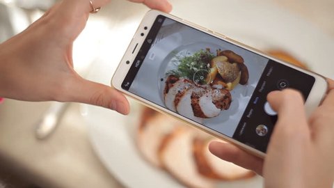Woman Hands Taking Photos Of Dinner Food By Smartphone. Closeup