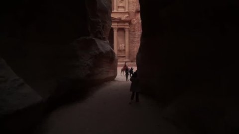 Wadi Musa / Jordan - October 2018: Tourist entering the Treasury through the Siq canyon in Petra, Jordan, Middle East.