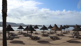 People have relax in a sandy beach in the Island of Tenerife, Spain, in winter time, since it is always good weather at the Canary Islands. HD Video. Holiday and relaxation.