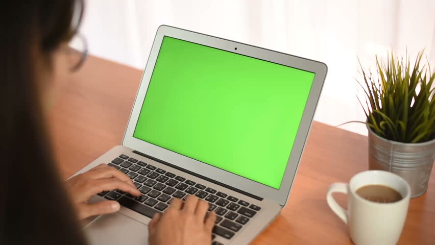 Young business start up, Young Owner Woman Start up for Business Online Working at home, Over the shoulder shot of a woman typing on a computer laptop with a key-green screen in home.