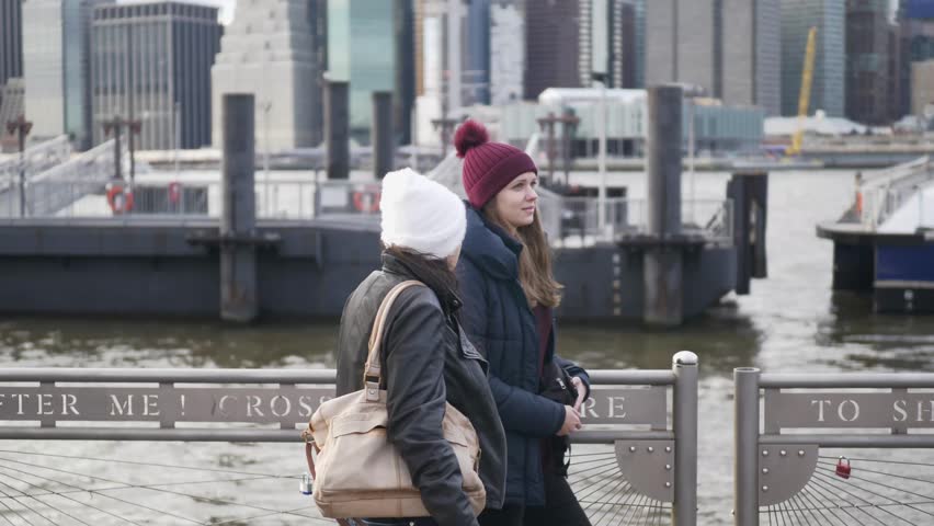 Two girls on a sightseeing tour to New York City at Hudson River
