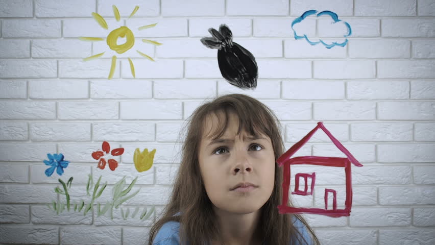 Fear of war. Sad child looks at the drawing of war.