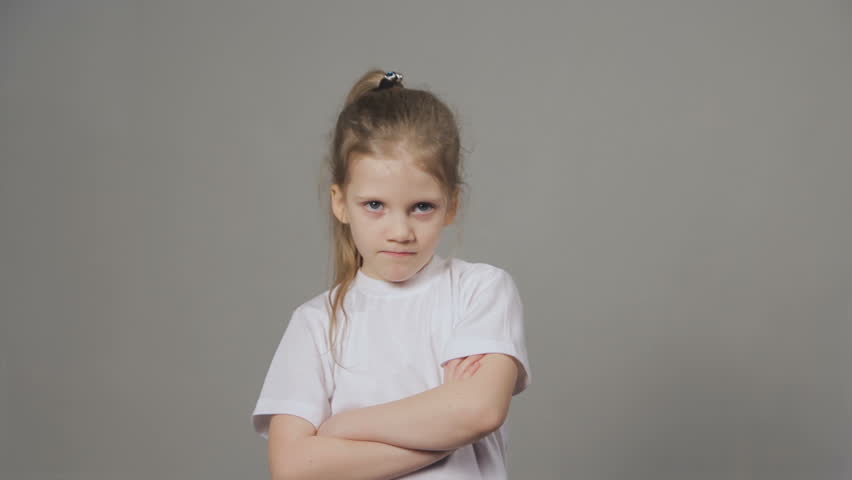 Portrait of young angry girl threatens with a shaking fist isolated on grey background. Concept of emotions. Royalty-Free Stock Footage #1021016284