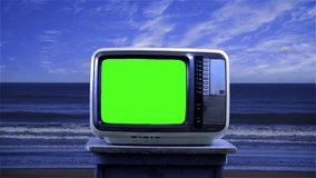 Old Television with Green Screen on Beach. Blue Tone. Close Up. Zoom In. You can replace green screen with the footage or picture you want. You can do it with “Keying” effect in After Effects.