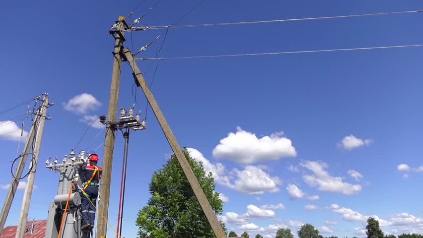 Remont power transformer. Maintenance of overhead power lines. Electrician lineman repairman worker at climbing work on electric post power pole and change transformer.
 Royalty-Free Stock Footage #1021033393