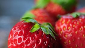 Close up footage view of strawberry fruits on wooden table. Selective focus.
