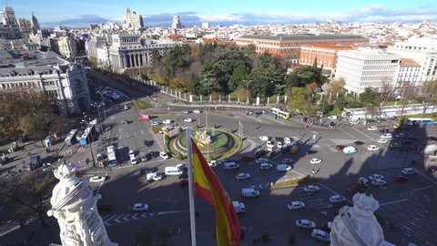 Aerial and panorama view of city rush hour traffic in Cibeles fountain at Plaza de Cibeles, an iconic place of Madrid, Spain