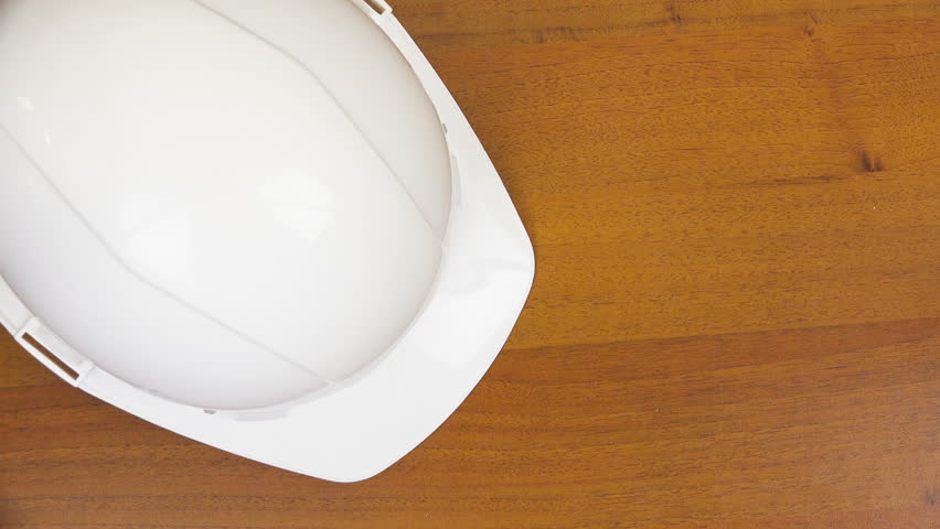 There is a white helmet and stones on the table.