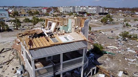 Mexico Beach, Florida, USA - Oct. 13, 2018: Hurricane Michael wind destroyed and exposed upper floor of home, aerial closeup flyover
