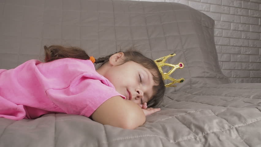 Beautiful girl sleeping in the crown. Charming sleeping princess.