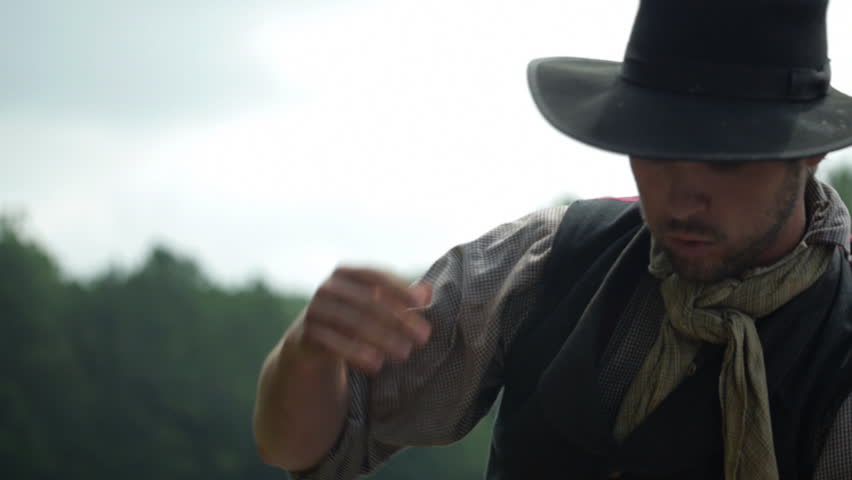 Man swinging tool - digging and building railroad - mid-19th century. 1800s Western Transcontinental Railroad construction. Re-enactment recreation of California Gold Rush era. Laboring in the sun.
