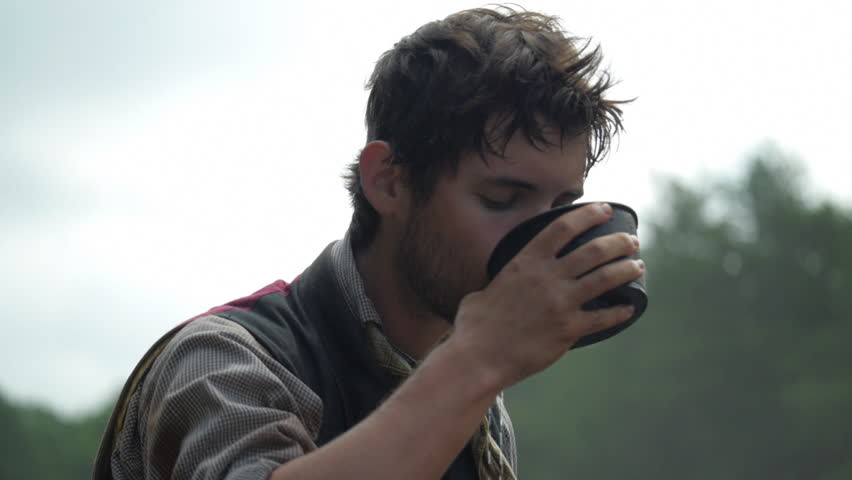 Man swinging tool - digging and building railroad - mid-19th century. 1800s Western Transcontinental Railroad construction. Re-enactment recreation of California Gold Rush era. Laboring in the sun.
