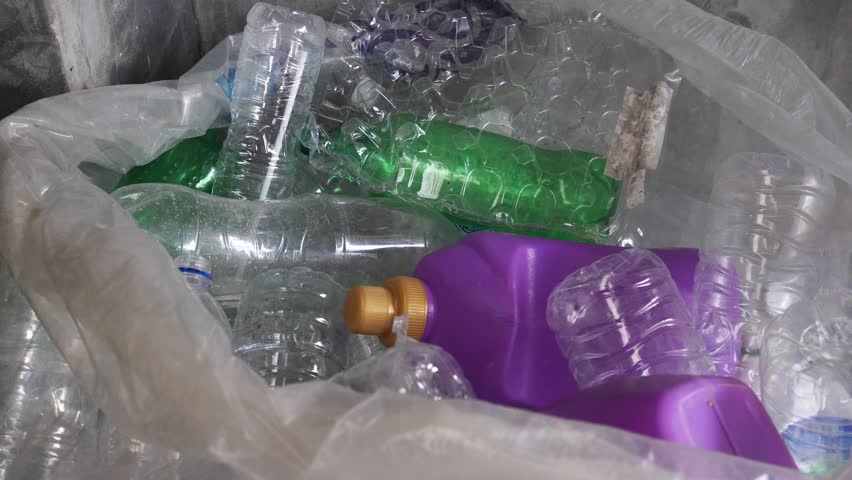 Hand getting plastic bottles to dispose in garbage bag ready to recycle, waste management and plastic recycle Royalty-Free Stock Footage #1021090219