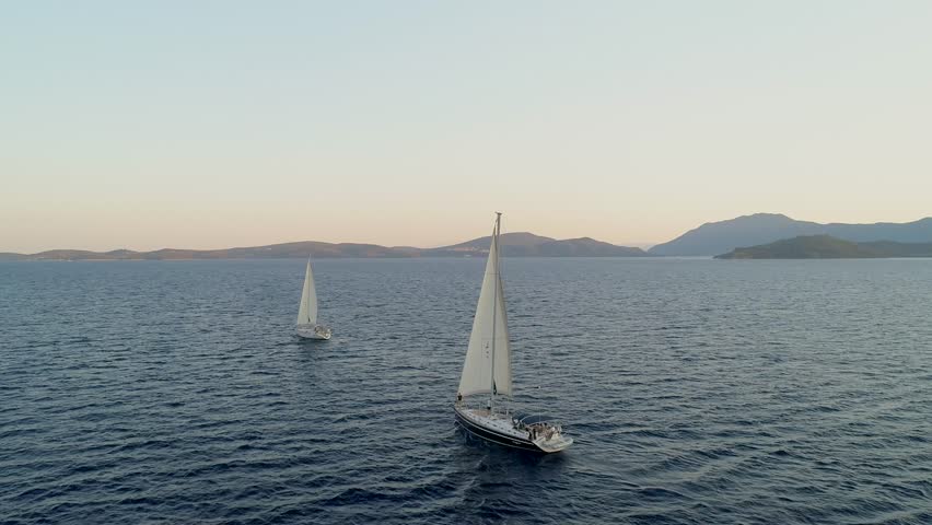 Aerial view of two sailboat anchored in the mediterranean sea, Vathi, Greece. | Shutterstock HD Video #1021101634