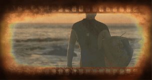 Old Movie tape showing surfer holding surfboard at the beach