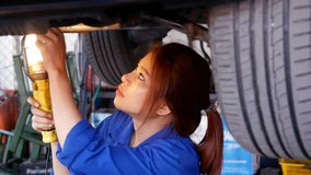 Mechanic woman try to fix car. people with car service, repair and maintenance concept. mechanic woman with lamp working at workshop - Powered by Shutterstock - Get 15% off with code: PIKWIZARD15