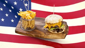Composite image of burger and fries food plate against animated american flag background - Powered by Shutterstock - Get 15% off with code: PIKWIZARD15