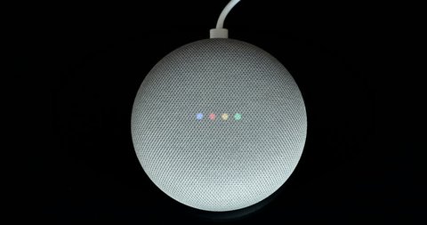 Paris, France - December 17 2018: Overhead View Of A Google Home Mini With Cable (Chalk Color), Black Background. Smart Speaker With The Google Assistant, Virtual Assistant - DCI 4K