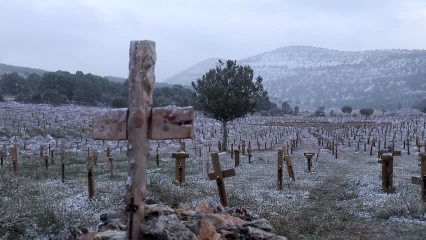 Wooden cross grave while snowing, spiritual