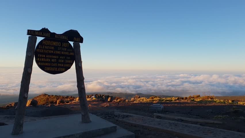 View From Horombo Hut Sign at Sunset Above The Couds on Kilimanjaro