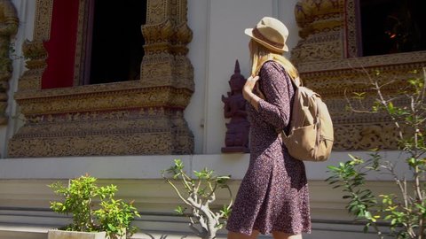 Young Female Tourist Visiting Traditional Buddhist Temple in Thailand