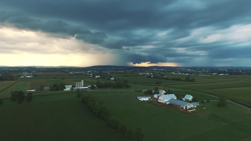 Aerial view of a big storm forming on the horizon over the farms of the Amish Country of Lancaster, Pennsylvania.