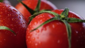 Close up footage of fresh tomato fruits on wooden table top. Selective focus.