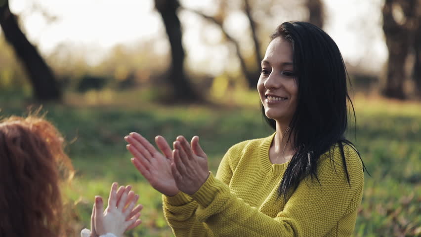 Mom and daughter hands playing. Happy family in autumn park