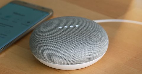 Paris, France - December 17 2018: Google Home Mini On The Wooden Table (Chalk Color). Smart Speaker With The Google Assistant, Virtual Assistant Powered By Artificial Intelligence - DCi 4K Resolution