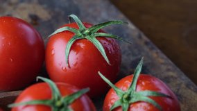 Close up footage of tomatoes on wooden table. Selective focus.
