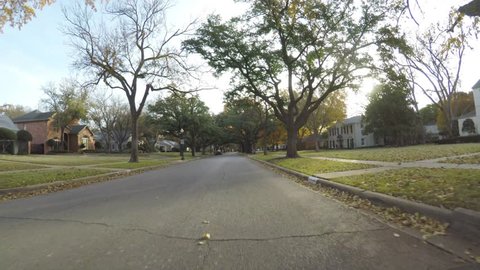 Wichita falls, Texas, USA - December 6, 2018.  POV. point view of streets in residential neighborhood with beautiful golden, yellow, red and green colors of trees in autumn.