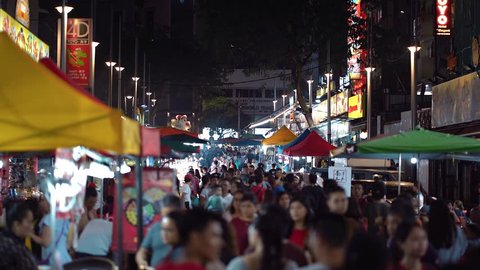 BUKIT BINTANG, KUALA LUMPUR - DEC 2018 : People walking at Jalan Alor Night Market, Bukit Bintang. A famous tourists attraction.