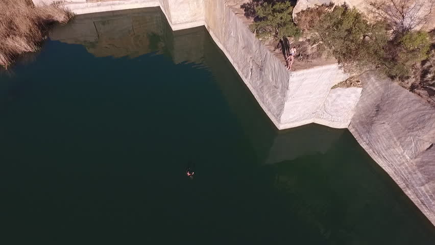 Aerial shot of a person diving from a high platform
