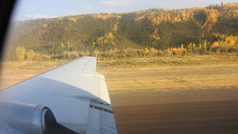 View from the passengers seat of an airplane taking off in Alaska.