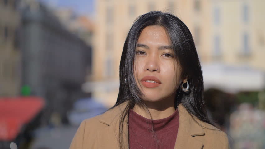 Asian young beautiful woman staring at camera in the city- slow motion | Shutterstock HD Video #1021160680