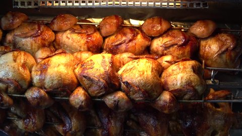 Whole roasted chicken rotating grilled on fire, barbecue for sale in the gourmet market.Delicious tasty and High protein nutrition for healthy.Food,Business,Easter Concept.