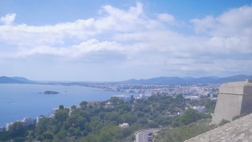 Beautiful view from the fortress in old town Dalt Vila to the port and new town in Ibiza, Spain. Blue sea and clouds in the harbor. Ibiza Town, Eivissa