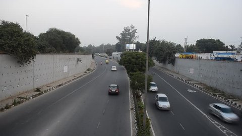 Delhi, India, 2019. Top angle pan shot of the traffic during the day from the above the underpass bridge in Dwarka, Delhi