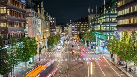 STOCKHOLM, SWEDEN - OCTOBER 22, 2014: Stockholm downtown city street at night Time Lapse. Tramway and traffic lights