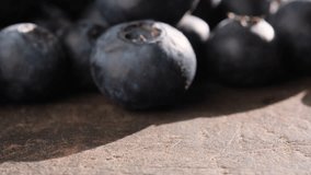 Close up footage of blueberry fruits on wooden table. Selective focus.