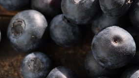 Close up footage of blueberry fruits on wooden table. Selective focus.