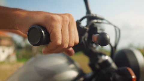 Close up of male hand holding twist grip throttle. Motorcyclist riding motorbike, revving the engine