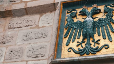 Emblem of Nuremberg, Germany on the wall in the historic part of the city. Black headed eagle