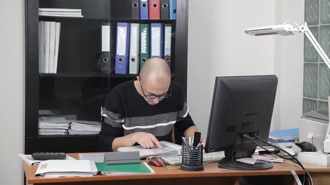 a man working in the office in the workplace. too much work