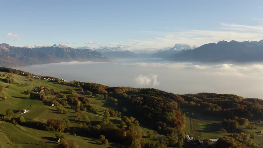 Aerial over farm fields and forest on autumn colors. Mist over Lake Léman, the Alps in the background.
Mont Pélerin, Vaud - Switzerland